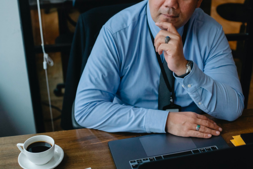 A business owner sits at his desk while working on his computer.