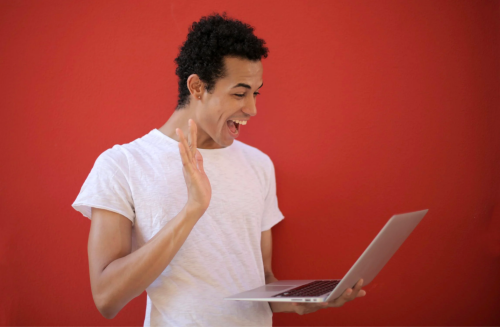 A business owner hosts a meeting on his computer using the internet.